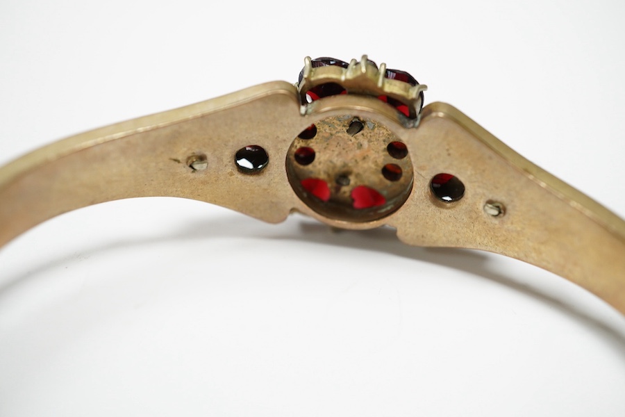 Three items of gilt white metal and garnet paste cluster set jewellery, comprising a bracelet, bangle and pair of Czechoslovakian earrings. Condition - fair